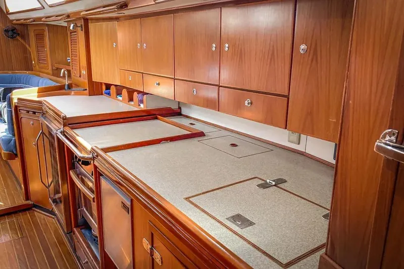 Slide: The Image of Interior of a 1999 Hylas 54 yacht with wooden cabinetry and countertops. - 17