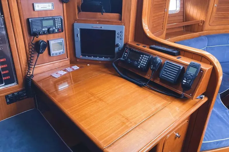 Slide: The Image of Navigation station on a 1999 Hylas 54 yacht with communication equipment and wooden finish. - 19