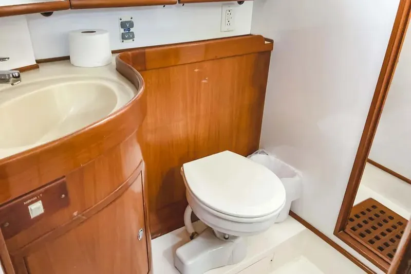 Slide: The Image of Luxurious bathroom in 1999 Hylas 54 yacht with wooden cabinetry and modern fixtures. - 23