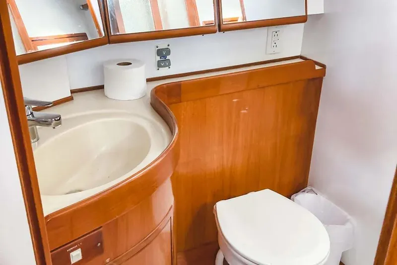 Slide: The Image of Bathroom interior of 1999 Hylas 54 yacht with wooden cabinetry and modern fixtures. - 28