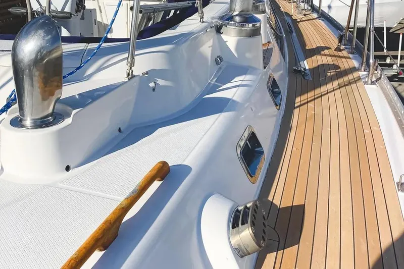 Slide: The Image of Deck of a 1999 Hylas 54 yacht with teak flooring and stainless steel fittings. - 4