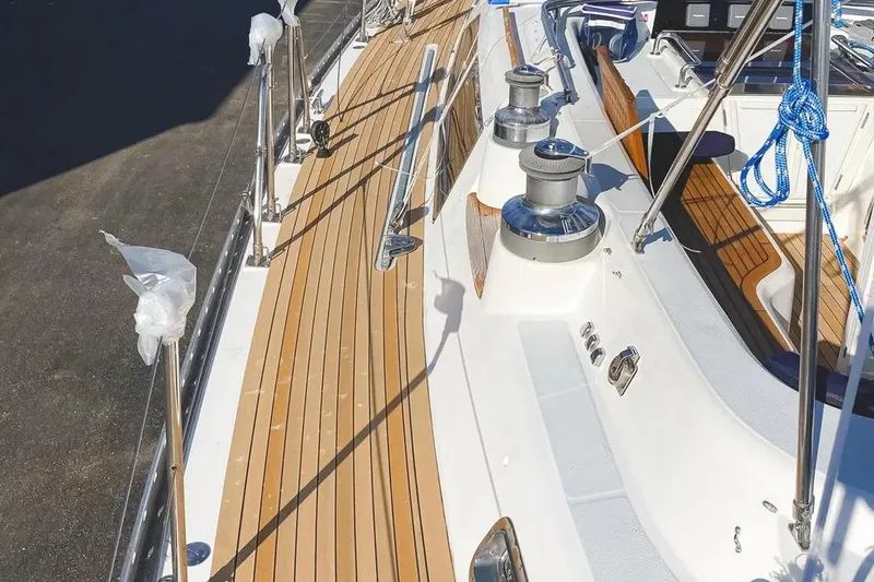 Slide: The Image of Deck view of a 1999 Hylas 54 yacht with teak flooring and winches. - 5