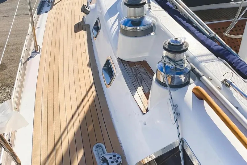 Slide: The Image of Deck of a 1999 Hylas 54 yacht with winches and teak flooring. - 6