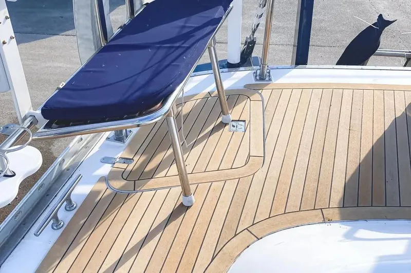Slide: The Image of Teak deck of a 1999 Hylas 54 yacht with a blue cushioned seat. - 7