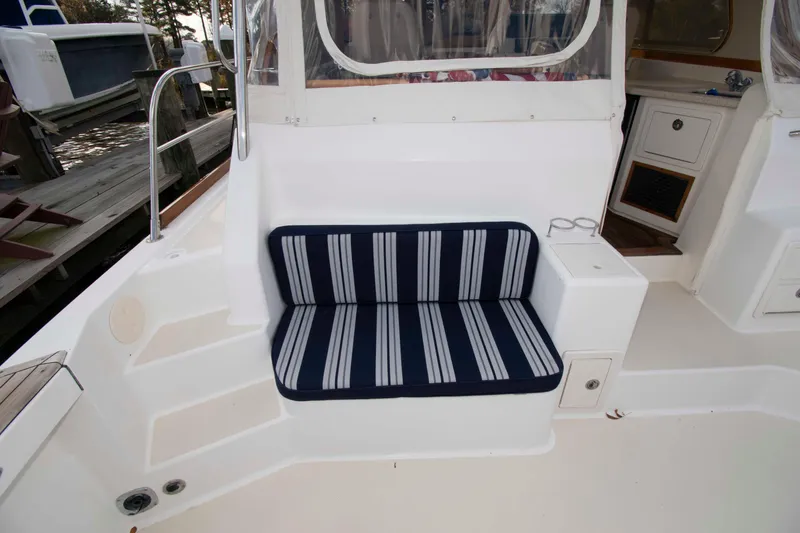 Slide: The Image of 2005 Sabre 38 Hardtop Express yacht docked, showcasing sleek design and polished railings. - 11