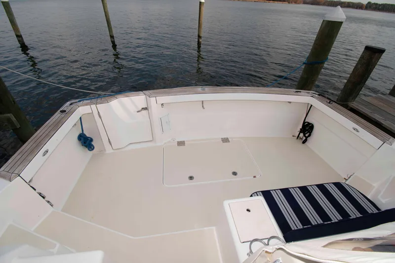 Slide: The Image of 2005 Sabre 38 Hardtop Express yacht docked, showcasing sleek design and polished railings. - 12