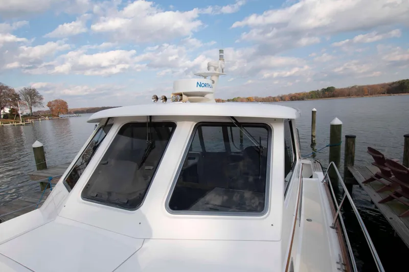 Slide: The Image of 2005 Sabre 38 Hardtop Express boat with striped seating and open cockpit view. - 14