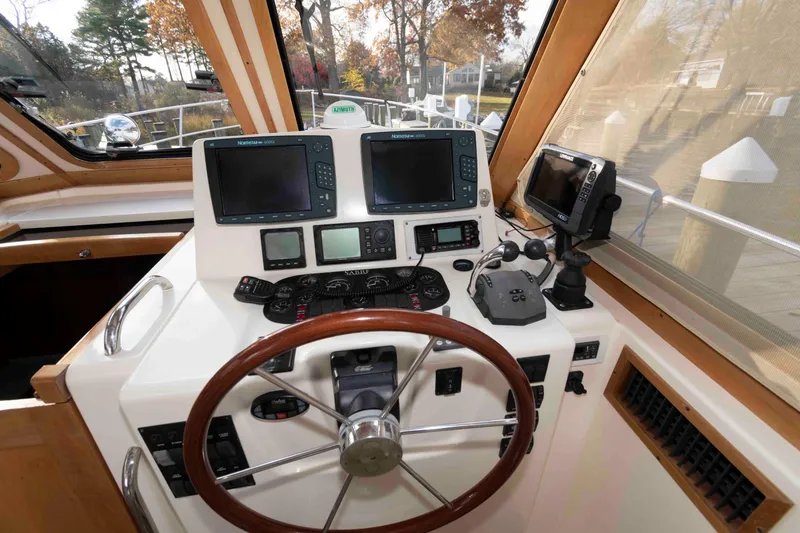 Slide: The Image of Bow view of 2005 Sabre 38 Hardtop Express at dock, showcasing anchor and railings. - 18