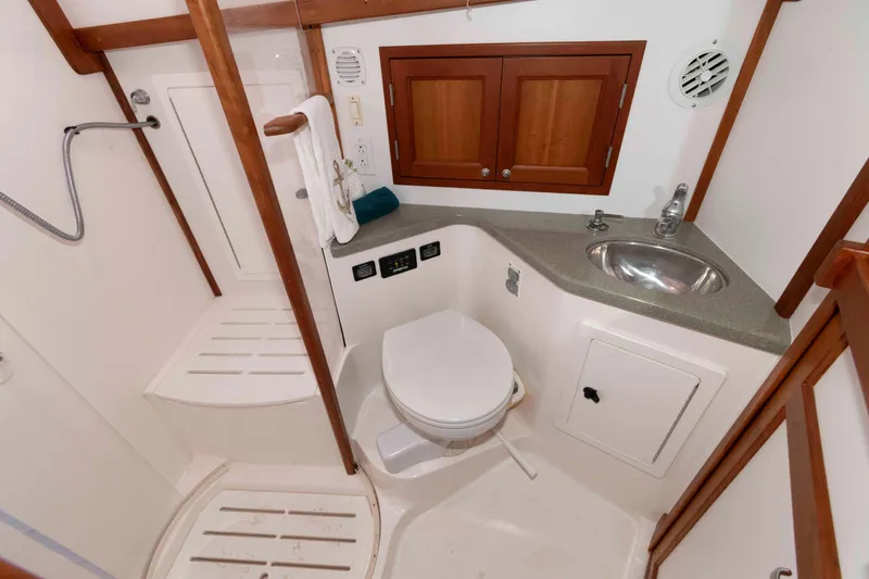 Slide: The Image of Luxurious interior of 2005 Sabre 38 Hardtop Express yacht with wood finish and cozy seating. - 26