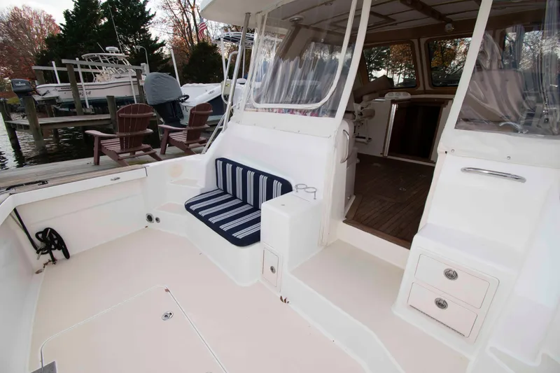 Slide: The Image of 2005 Sabre 38 Hardtop Express docked at a marina on a calm day. - 9