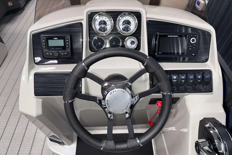 Slide: The Image of 2026 Sylvan Mirage X3 boat dashboard with steering wheel, gauges, and control panel. - 7