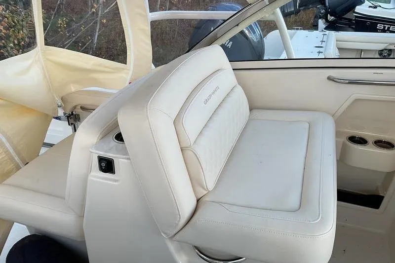 Slide: The Image of 2025 Grady-White Freedom 285 boat interior with white seating and cup holders. - 10