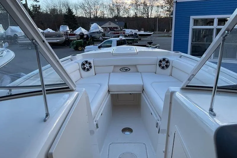Slide: The Image of 2025 Grady-White Freedom 285 boat interior with white seating and speakers. - 6