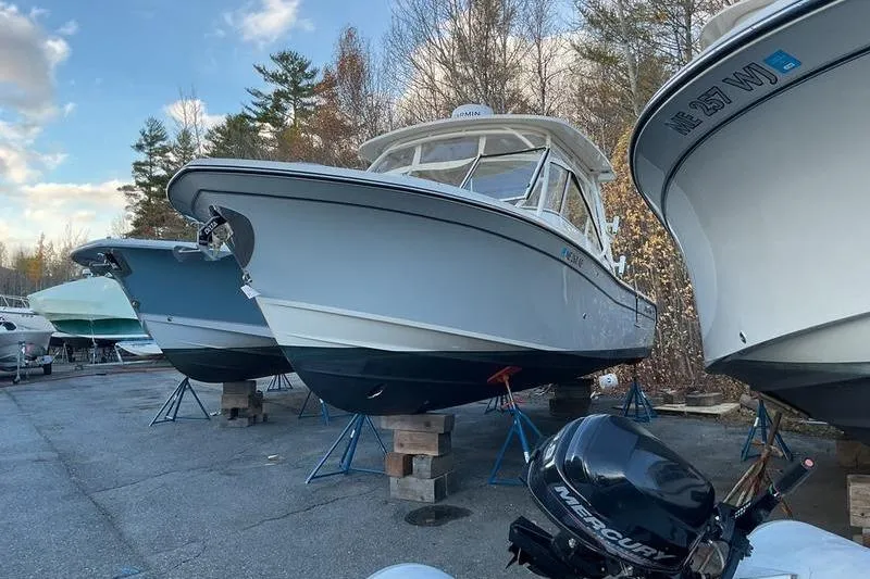 Slide: The Image of 2025 Grady-White Freedom 285 boat on stands, outdoor storage setting. - 7