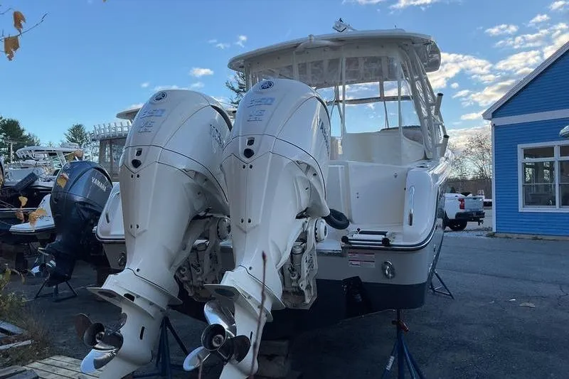 Slide: The Image of 2025 Grady-White Freedom 285 boat with dual outboard engines, parked outdoors. - 8
