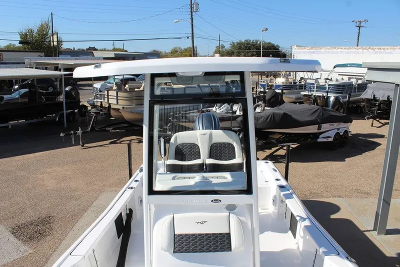 Slide: The Image of 2025 Tidewater 2210 Carolina Bay boat displayed at a dealership. - 14