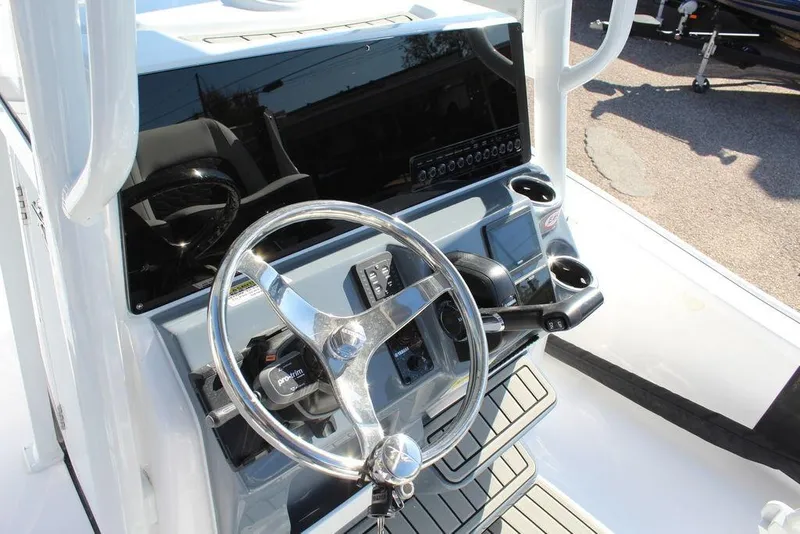 Slide: The Image of 2025 Tidewater 2210 Carolina Bay boat console with steering wheel and controls. - 20