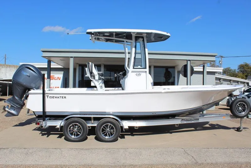 Slide: The Image of 2025 Tidewater 2210 Carolina Bay boat on trailer, parked outside a building. - 3
