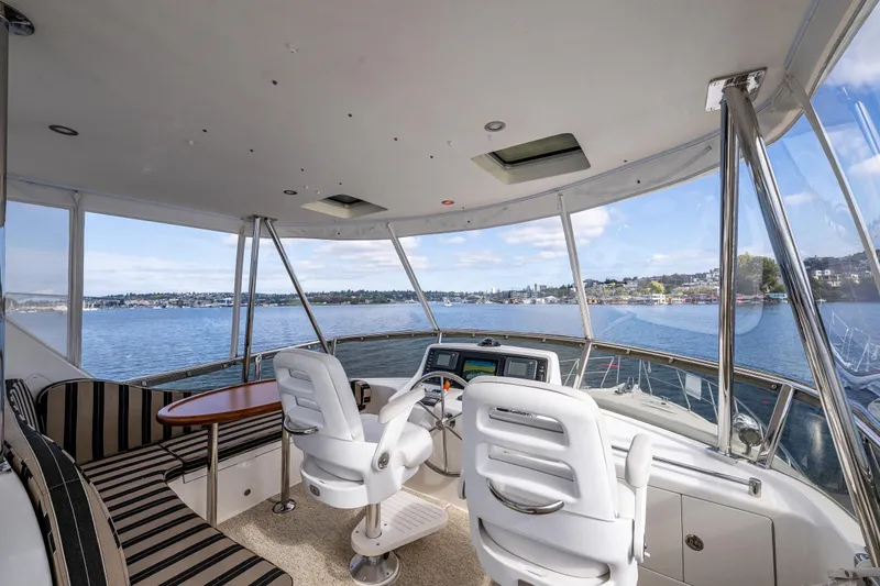 Slide: The Image of Helm Station of 2009 Ocean Alexander 52 Sedan yacht with panoramic visibility. Provides wonderful area to enjoy family and full wrap around water views. - 18