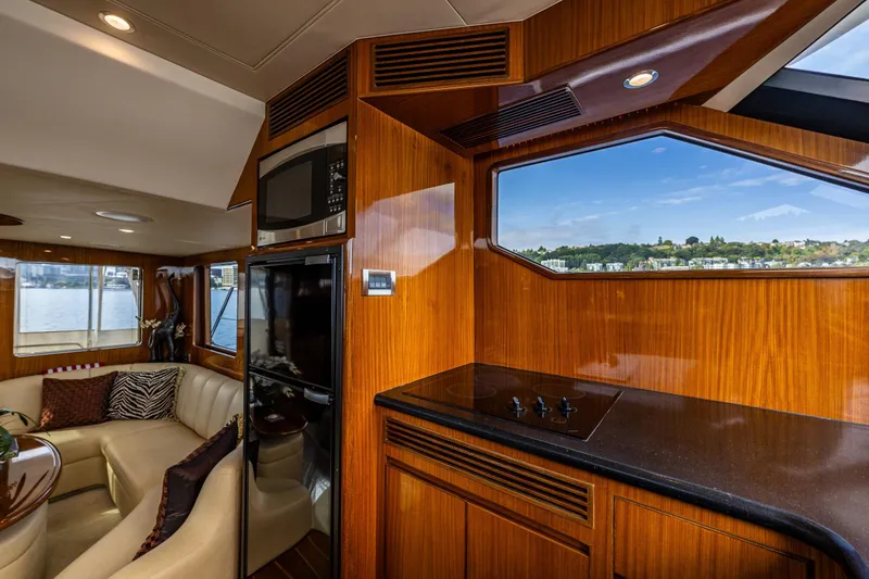 Slide: The Image of Luxurious galley of 2009 Ocean Alexander 52 Sedan yacht with elegant wood finishes. - 29