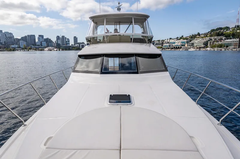 Slide: The Image of 2009 Ocean Alexander 52 Sedan yacht on water with city skyline in background. - 6