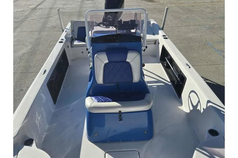 Slide: The Image of 2020 Blue Wave 2400 PureBay boat interior with blue and white seating. - 10