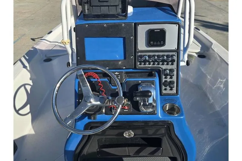 Slide: The Image of Center console of 2020 Blue Wave 2400 PureBay boat with steering wheel and controls. - 12