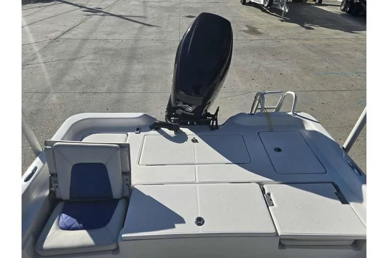 Slide: The Image of 2020 Blue Wave 2400 PureBay boat deck with motor and seating area. - 13