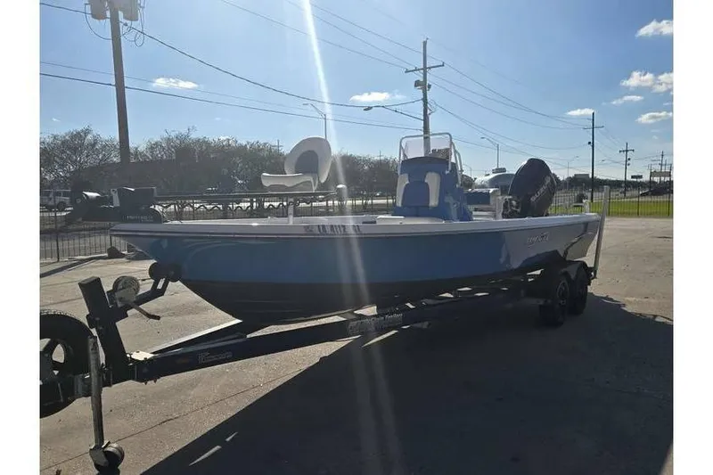 Slide: The Image of 2020 Blue Wave 2400 PureBay boat on trailer under clear sky. - 3