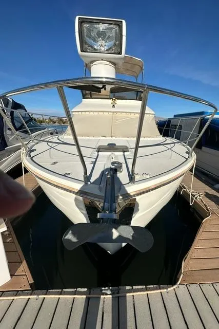 Slide: The Image of 2016 Carver C34 Command Bridge yacht docked, front view with anchor and spotlight. - 28