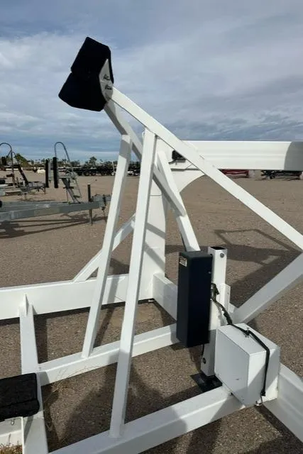 Slide: The Image of Boat trailer support structure for Carver C34 Command Bridge, 2016 model, under a cloudy sky. - 30