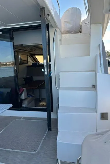 Slide: The Image of 2016 Carver C34 Command Bridge yacht interior with stairs and seating area. - 5