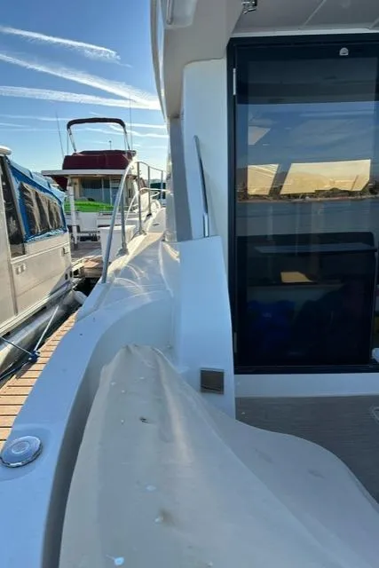 Slide: The Image of 2016 Carver C34 Command Bridge yacht docked, showcasing sleek design and modern features. - 6