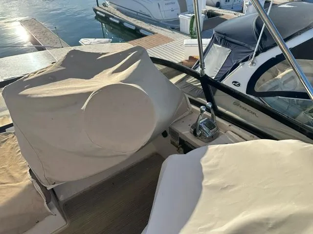 Slide: The Image of 2016 Carver C34 Command Bridge yacht with covered helm station at marina. - 7