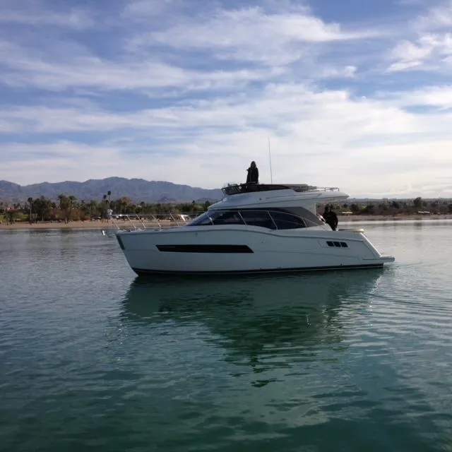 The Image of 2016 Carver C34 Command Bridge yacht on calm water under a clear sky. - 0