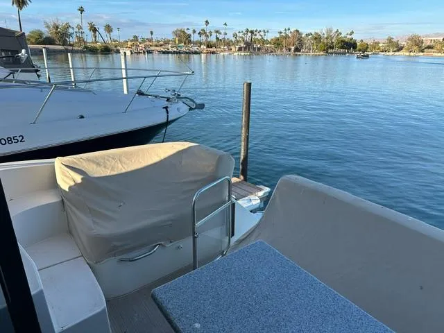 Slide: The Image of 2016 Carver C34 Command Bridge yacht docked by serene waterfront. - 10