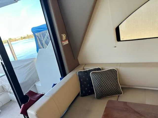 Slide: The Image of Interior of 2016 Carver C34 Command Bridge yacht with beige seating and decorative pillows. - 15