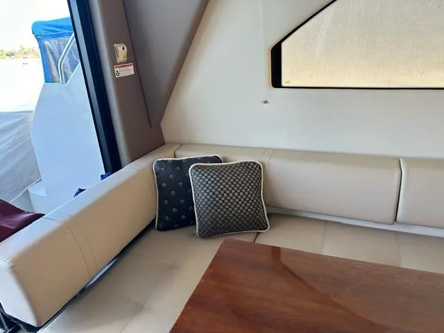 Slide: The Image of Interior of 2016 Carver C34 Command Bridge with cushioned seating and decorative pillows. - 20