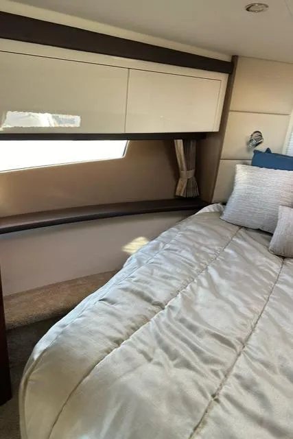 Slide: The Image of Interior of 2016 Carver C34 Command Bridge yacht bedroom with bed and window. - 24