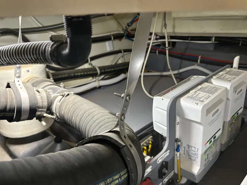 Slide: The Image of Engine room of 2016 Carver C34 Command Bridge with visible wiring and components. - 35