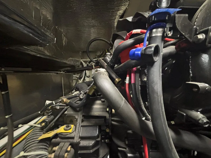 Slide: The Image of Engine compartment of a 2016 Carver C34 Command Bridge with visible hoses and components. - 37