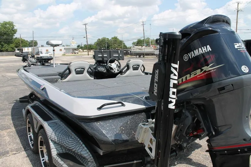Slide: The Image of 2021 Skeeter FXR21 boat with Yamaha engine, parked outdoors under a cloudy sky. - 9