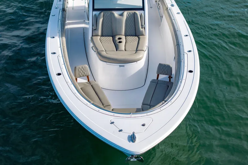 Slide: The Image of 2022 Sportsman Open 352 Center Console boat with luxurious seating on calm water. - 10