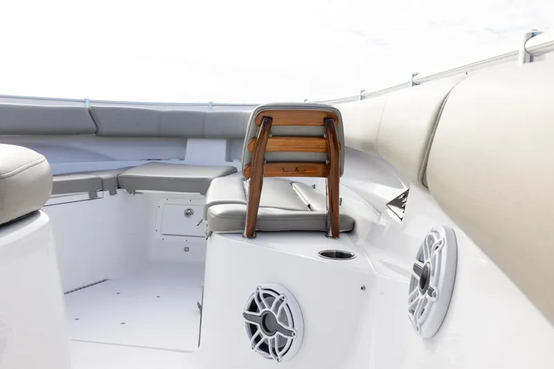 Slide: The Image of 2022 Sportsman Open 352 Center Console boat interior with cushioned seating and speakers. - 15