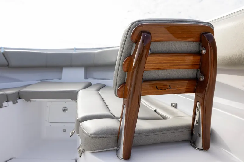 Slide: The Image of 2022 Sportsman Open 352 Center Console boat with cushioned seating and wooden accents. - 16