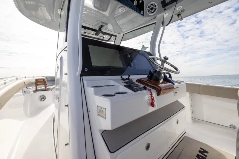 Slide: The Image of 2022 Sportsman Open 352 Center Console boat interior with steering wheel and controls. - 20