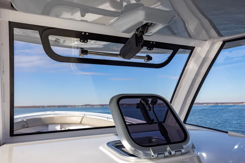 Slide: The Image of 2022 Sportsman Open 352 Center Console boat interior with ocean view through windshield. - 21