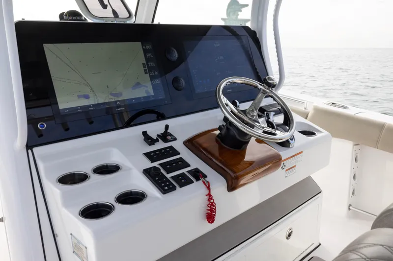 Slide: The Image of 2022 Sportsman Open 352 Center Console dashboard with steering wheel and navigation screens. - 22