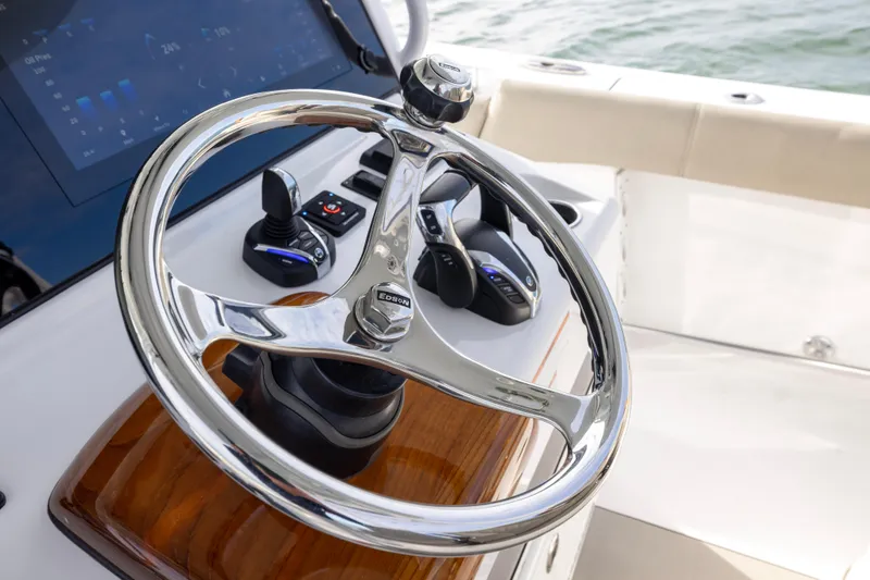Slide: The Image of 2022 Sportsman Open 352 Center Console steering wheel and controls, featuring modern design. - 25