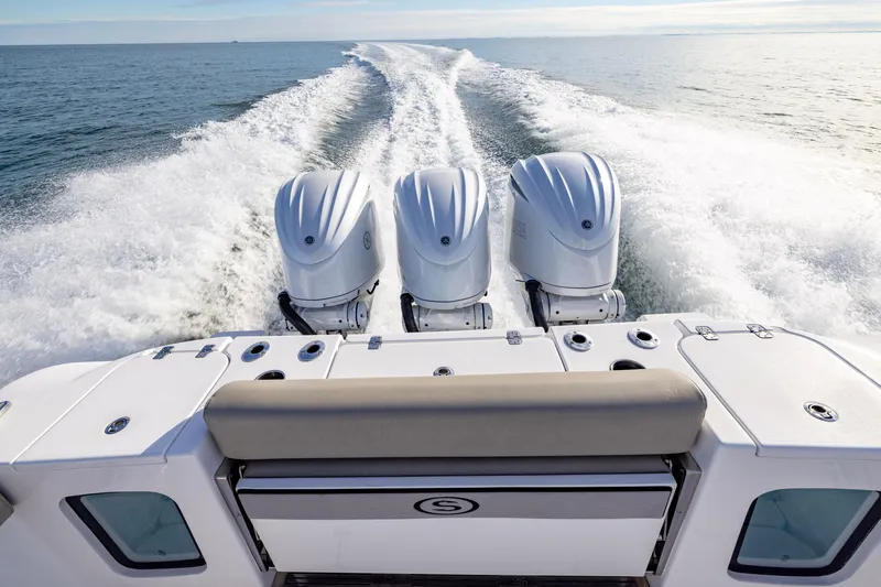 Slide: The Image of 2022 Sportsman Open 352 Center Console with triple engines cruising on open water. - 35